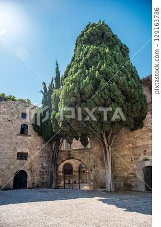 Medieval arched street in the old town of Rhodes, Greece 129163786