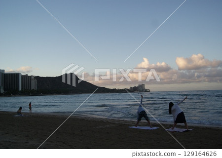 Early morning beach silhouette overlooking Diamond Head 129164626