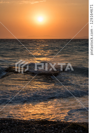 Aegean sea sunset beach sea Rhodes, Greece Aegean sea sunset beach sea Rhodes, Greece 129164671