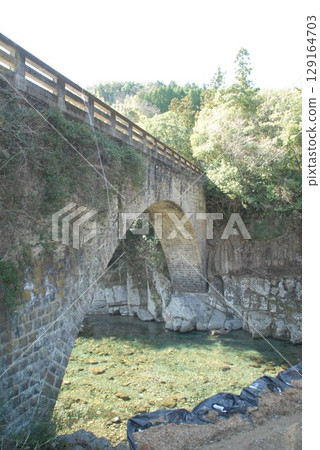 Shadows of an old stone bridge and a clear stream Shadows of an old stone bridge and a clear stream 129164703