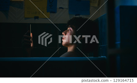 Tired And Stressed Man Lost In The Light Of The Smartphone Tired And Stressed Man Lost In The Light Of The Smartphone 129164715