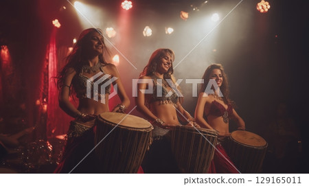 Belly dancers playing drums Belly dancers playing drums 129165011
