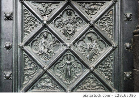Symbols for the four seasons on iron tiles at a side portal of the cathedral of Cologne, NRW, Germany Symbols for the four seasons on iron tiles at a side portal of the cathedral of Cologne, NRW, Germany 129165380