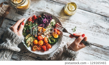 Woman Enjoying Colorful Vegetarian Salad Bowl Woman Enjoying Colorful Vegetarian Salad Bowl 129165481