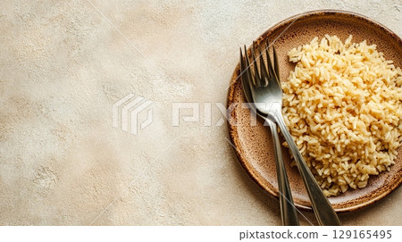 Empty Plate with Rice and Fork on Neutral Background 129165495