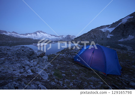 Tent at Oberer Schwarzhornsee lake with Hochalmspitze 3360 m, National Park Hohe Tauern, Carinthia, Austria Tent at Oberer Schwarzhornsee lake with Hochalmspitze 3360 m, National Park Hohe Tauern, Carinthia, Austria 129165798