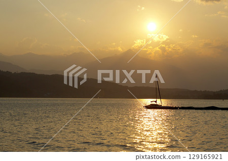 Sailing boats at Lake Millstatt during sunset, Carinthia, Austria 129165921