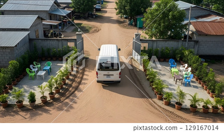 White Van Entering Gated Community With Greenery And Outdoor Seating From An Aerial View White Van Entering Gated Community With Greenery And Outdoor Seating From An Aerial View 129167014