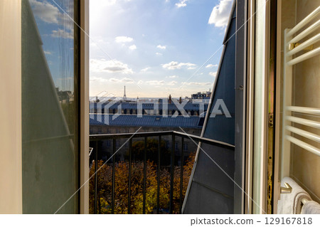 Open window with view of rooftops and Eiffel Tower in Paris, France Open window with view of rooftops and Eiffel Tower in Paris, France 129167818