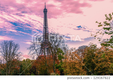 The Eiffel Tower is beautifully surrounded by lush greenery in the heart of Paris, France 129167822