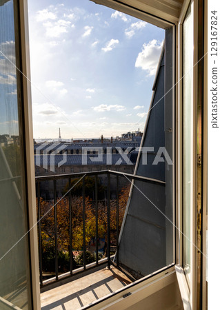 Open window with view of rooftops and Eiffel Tower in Paris, France 129167824