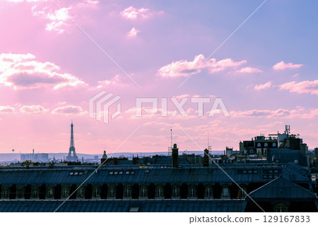 Romantic view of rooftops and Eiffel Tower with the sunset sky in Paris, France Romantic view of rooftops and Eiffel Tower with the sunset sky in Paris, France 129167833