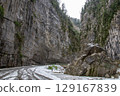 Snowy Road in a Mountain Canyon 129167839