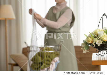 Senior woman doing housework, laundry and elderly woman 129168303