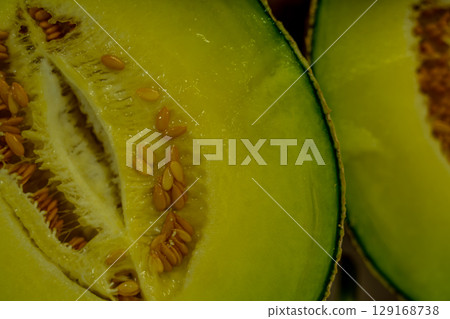 Cut in half cantaloupe melon isolated on white background 129168738