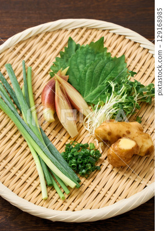 Assorted condiments: ginger, myoga, shiso leaves, green onions, and daikon radish 129168985