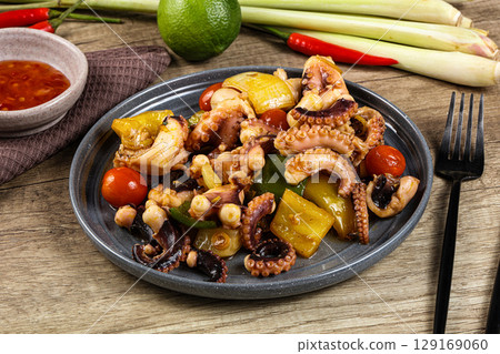 Roasted octopus with vegetables and oil Roasted octopus with vegetables and oil 129169060