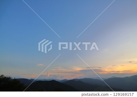 Sunset, blue sky, clouds, mountains, trees 129169157