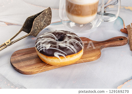 Delicous sweet donut with chocolate glaze 129169270