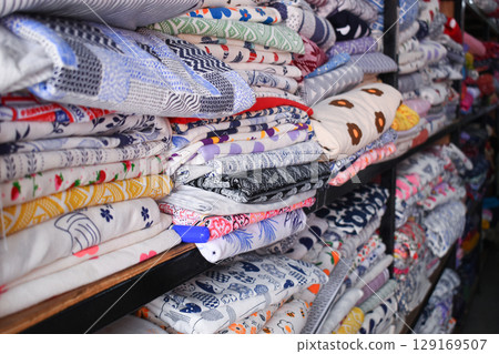 heap of colorful cloth on shelf for sale in store heap of colorful cloth on shelf for sale in store 129169507