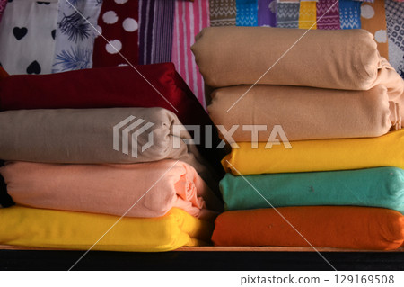 heap of colorful cloth on shelf for sale in store 129169508