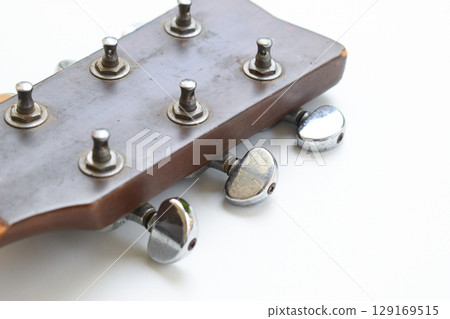 part of broken wood acoustic guitar isolated on white background 129169515