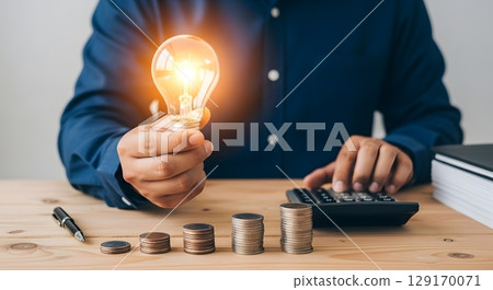 businessman working with a light bulb on the desk businessman working with a light bulb on the desk 129170071