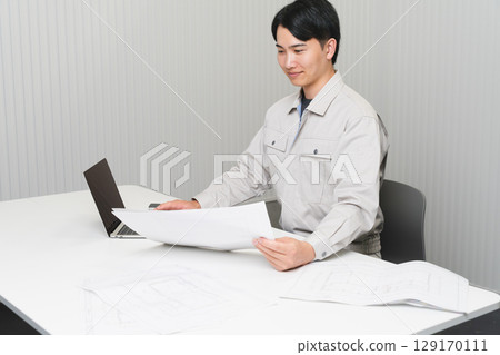 Young man wearing work clothes Construction image 129170111