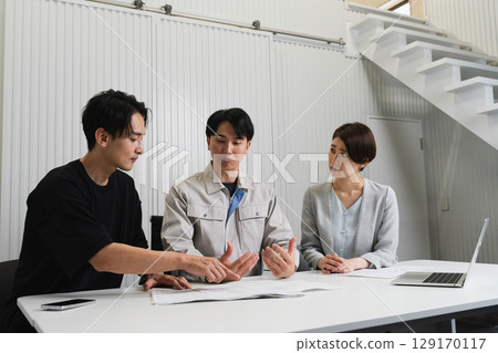 Construction site supervisor discussing with architect, architectural image 129170117