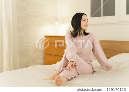 Young woman stretching on the bed Beauty image 129170123