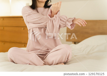 Young woman stretching on the bed Beauty image Young woman stretching on the bed Beauty image 129170125