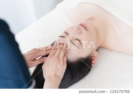A young woman receiving treatment from an esthetician. Beauty image A young woman receiving treatment from an esthetician. Beauty image 129170706