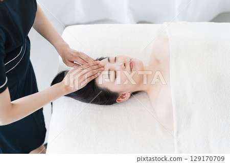 A young woman receiving treatment from an esthetician. Beauty image A young woman receiving treatment from an esthetician. Beauty image 129170709