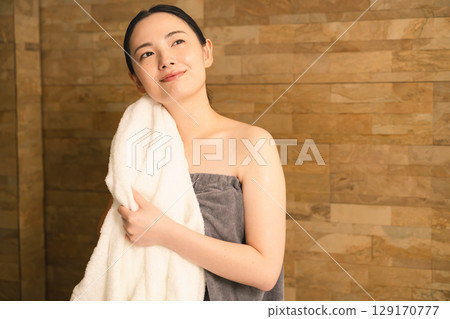 Young woman wiping sweat with a towel Beauty image Young woman wiping sweat with a towel Beauty image 129170777