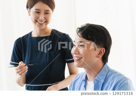 A young man having his eyebrows done by a makeup artist Beauty image 129171318