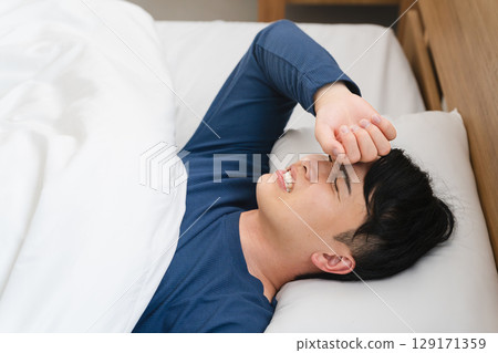 A young man sleeping with a nightmare. Lifestyle image A young man sleeping with a nightmare. Lifestyle image 129171359