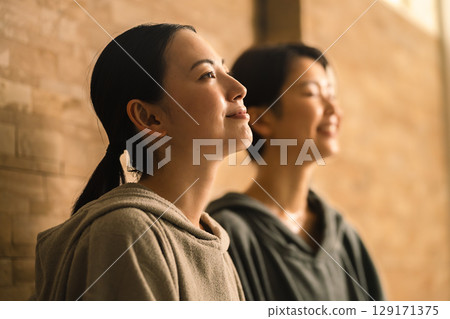 Two young women sweating in a sauna. Beauty image. 129171375