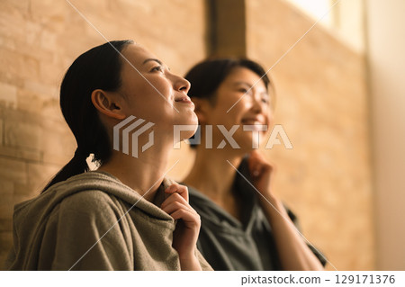 Two young women sweating in a sauna. Beauty image. 129171376