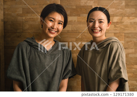 Two young women sweating in a sauna. Beauty image. 129171380