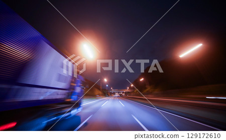 Cars driving on a national highway at night 129172610
