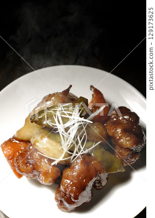 Hot sweet and sour pork with black vinegar 129173625