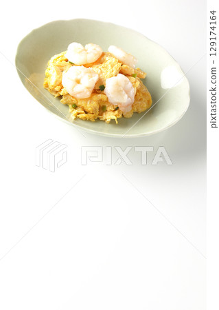Chinese stir-fried shrimp and eggs photographed on a white background 129174164