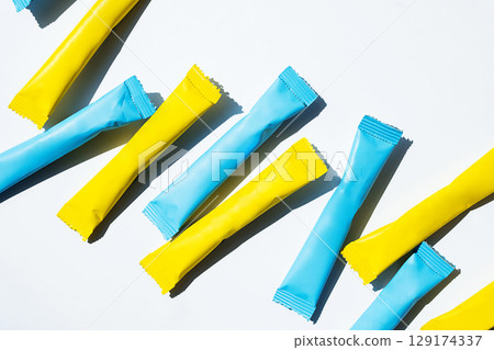 Yellow and blue stick pack energy drink and instant coffee mockup. 129174337