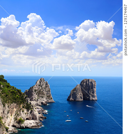 Top view on Faraglioni Rocks, Capri Island, Italy. Aerial view of landscape with azure sea, Capri island coastline and Faraglioni cliffs. Topic of travel, trip abroad on vacation, cruises and tours Top view on Faraglioni Rocks, Capri Island, Italy. Aerial view of landscape with azure sea, Capri island coastline and Faraglioni cliffs. Topic of travel, trip abroad on vacation, cruises and tours 129174467