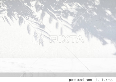 Marble Table with Shameplant Leaves Shadow on Stucco Wall Texture Background Marble Table with Shameplant Leaves Shadow on Stucco Wall Texture Background 129175290