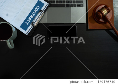 Justice and law concept.Lawyer workplace with laptop and documents with dark wooden in office. 129176740