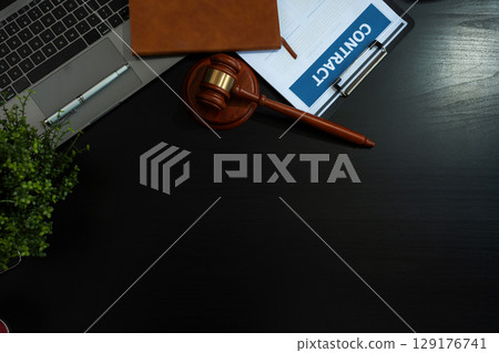 Justice and law concept.Lawyer workplace with laptop and documents with dark wooden in office. Justice and law concept.Lawyer workplace with laptop and documents with dark wooden in office. 129176741