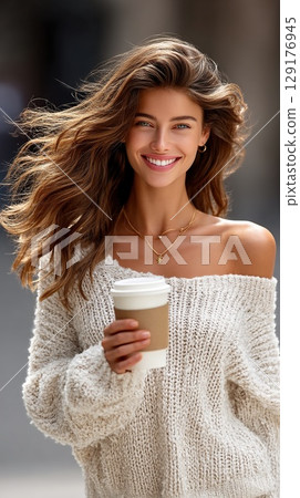 Happy woman enjoys her coffee outdoors on a beautiful day. 129176945