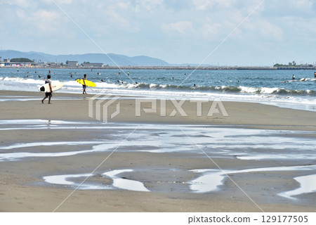 A surfer walking towards the sea at Tsujido Beach 129177505