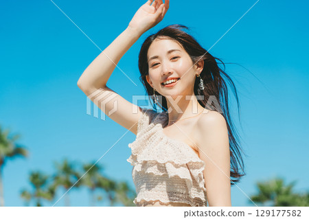 Young woman beach resort image Young woman beach resort image 129177582